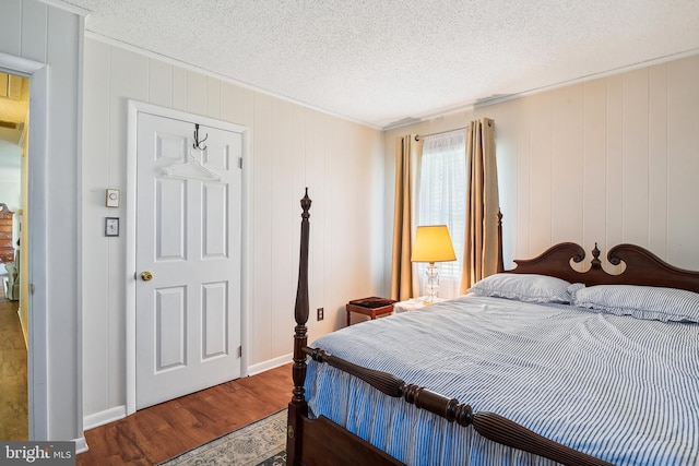 bedroom featuring hardwood / wood-style floors and a textured ceiling