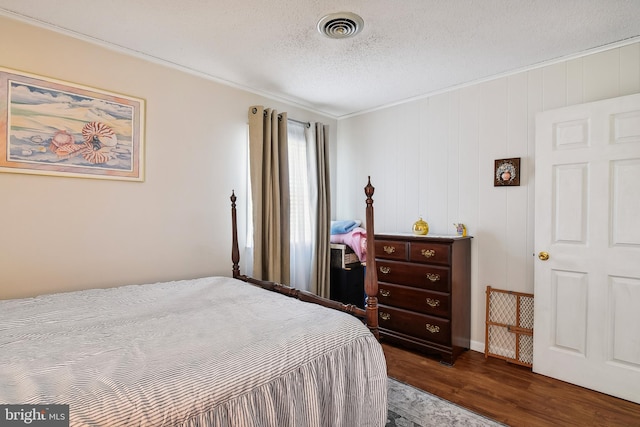 bedroom featuring dark hardwood / wood-style floors and a textured ceiling