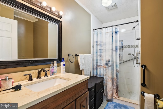 bathroom featuring vanity, a textured ceiling, a shower with shower curtain, and tile patterned flooring