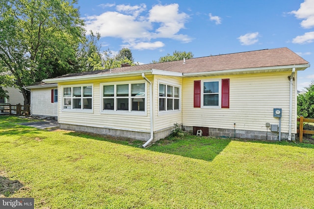 rear view of house with a yard