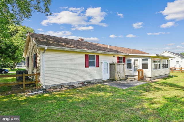 rear view of house with a lawn