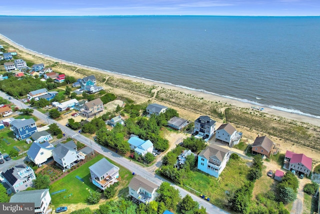 drone / aerial view featuring a water view and a beach view