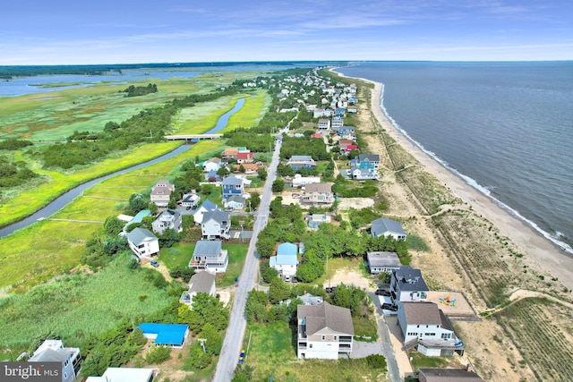 bird's eye view with a water view and a beach view