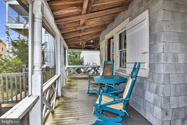 unfurnished sunroom featuring lofted ceiling with beams and wood ceiling