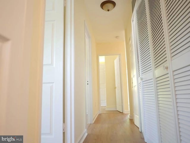 corridor with light hardwood / wood-style floors