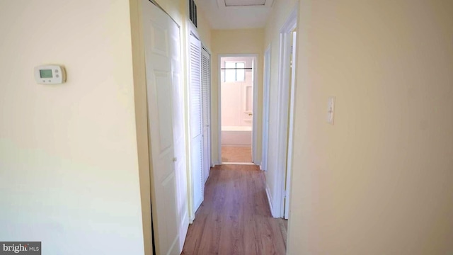 corridor with light wood-type flooring