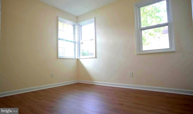 spare room with hardwood / wood-style floors