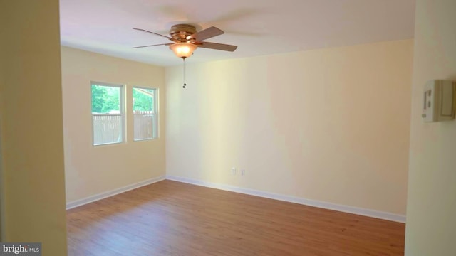 spare room featuring hardwood / wood-style flooring and ceiling fan