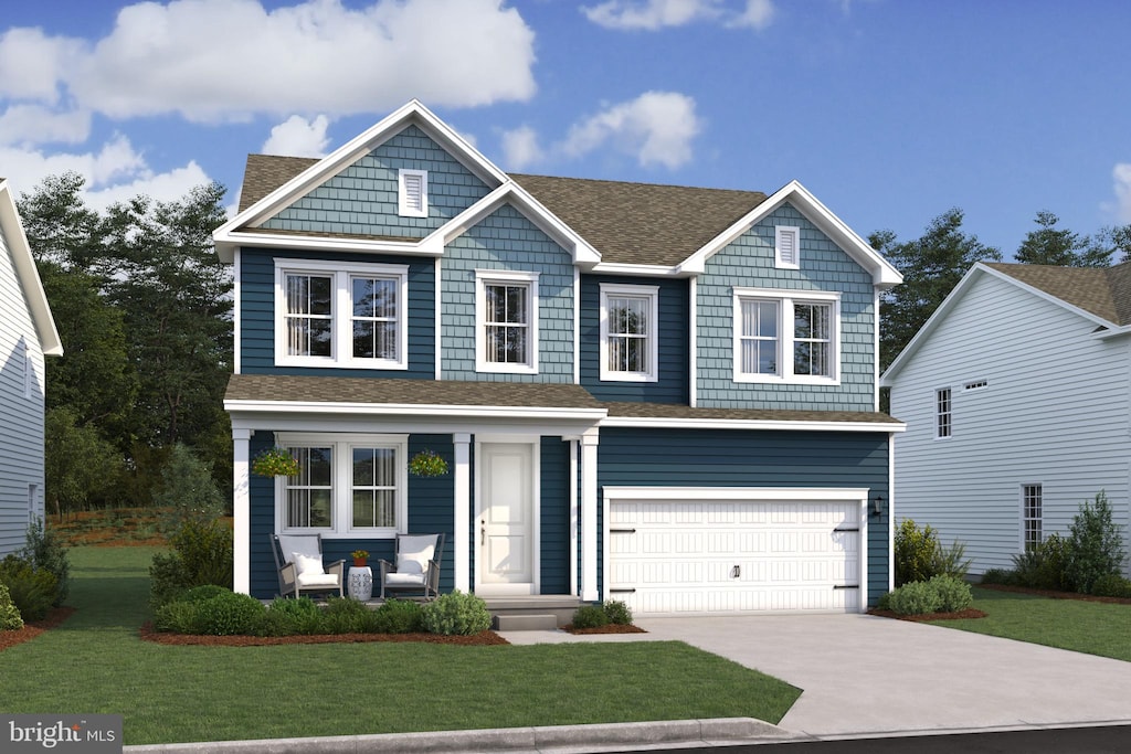 craftsman inspired home featuring a garage and a front lawn