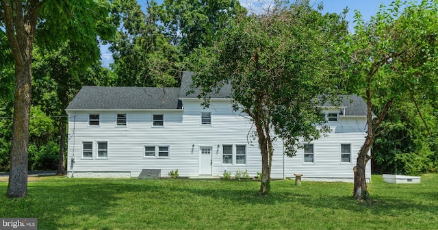 rear view of house with a yard