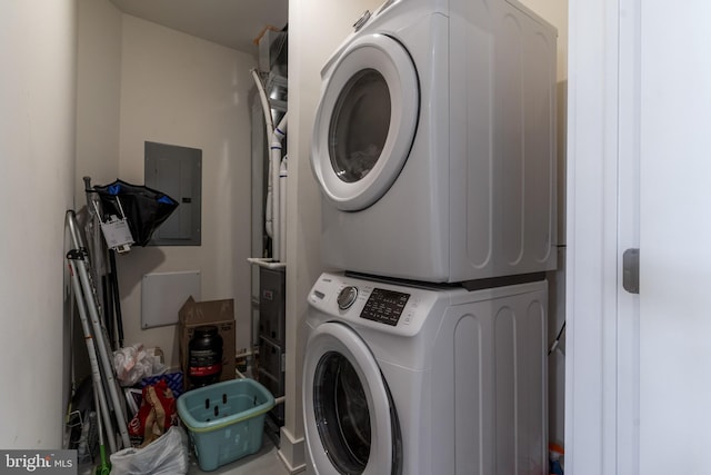 washroom with stacked washer and dryer and electric panel