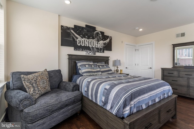 bedroom with dark hardwood / wood-style floors