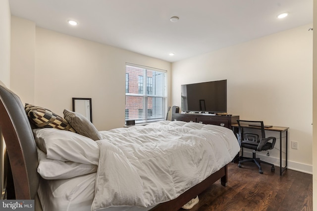 bedroom with dark hardwood / wood-style floors