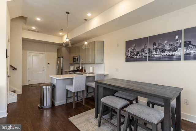 dining area featuring dark wood-type flooring