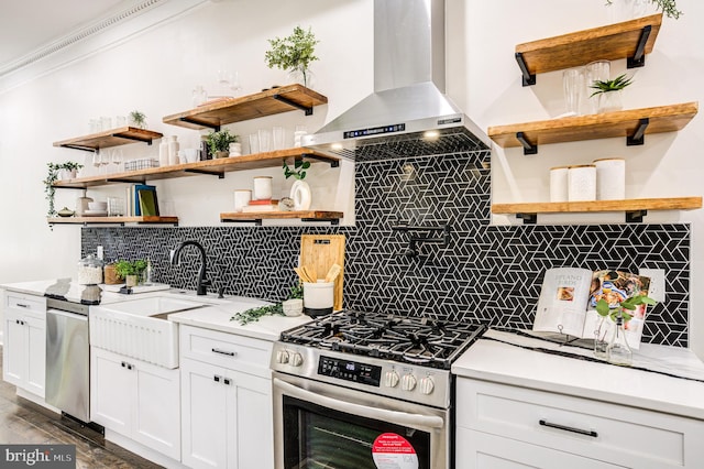 kitchen with dark wood-type flooring, tasteful backsplash, white cabinetry, wall chimney range hood, and stainless steel appliances