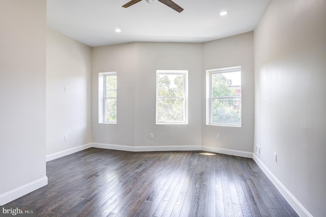 spare room with ceiling fan, plenty of natural light, and dark hardwood / wood-style flooring