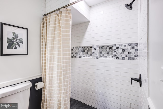 bathroom with toilet and curtained shower