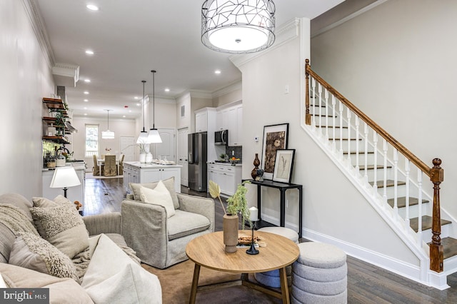 living room featuring dark wood-type flooring and crown molding