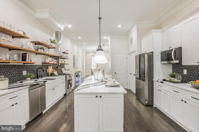 kitchen featuring a center island, appliances with stainless steel finishes, hanging light fixtures, and dark wood-type flooring