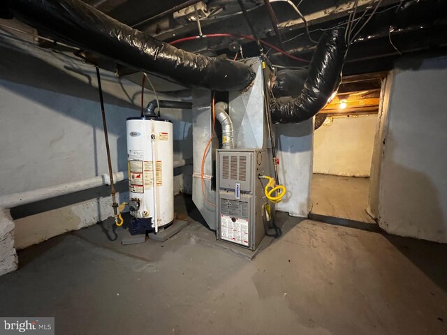 utility room with heating unit and water heater