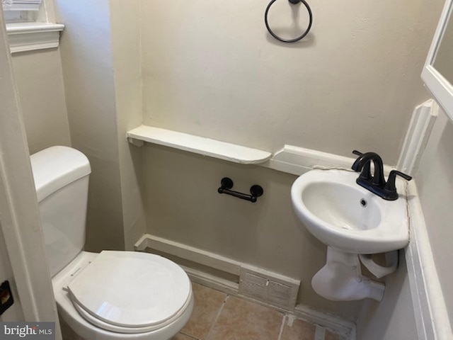 bathroom featuring sink, tile patterned floors, and toilet