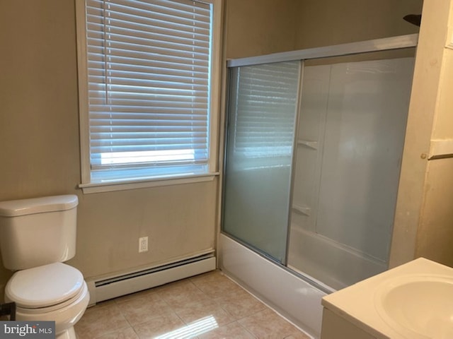 full bathroom featuring toilet, bath / shower combo with glass door, vanity, tile patterned floors, and baseboard heating