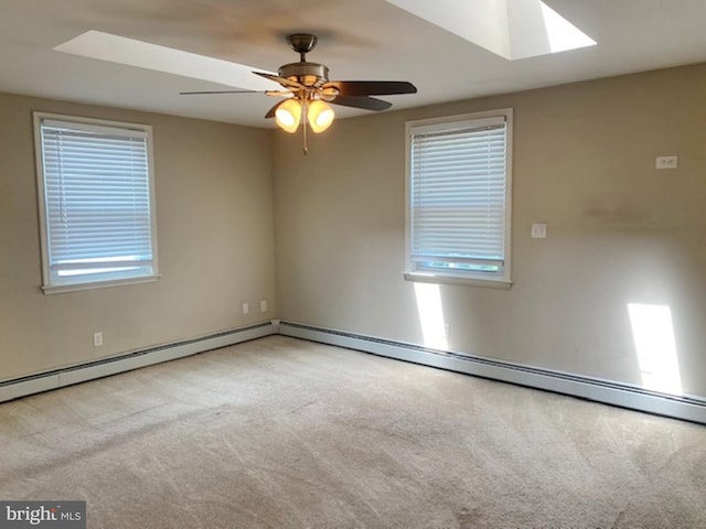 carpeted empty room featuring ceiling fan and baseboard heating