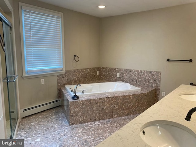 bathroom with vanity, a baseboard heating unit, and tiled tub