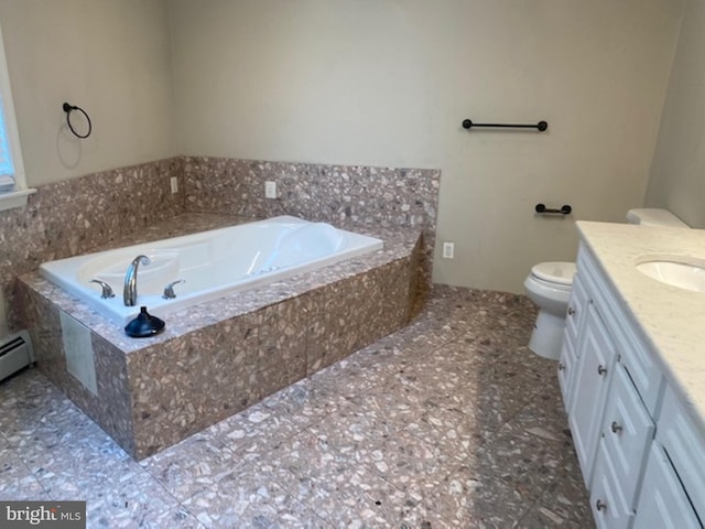 bathroom with toilet, vanity, and tiled bath