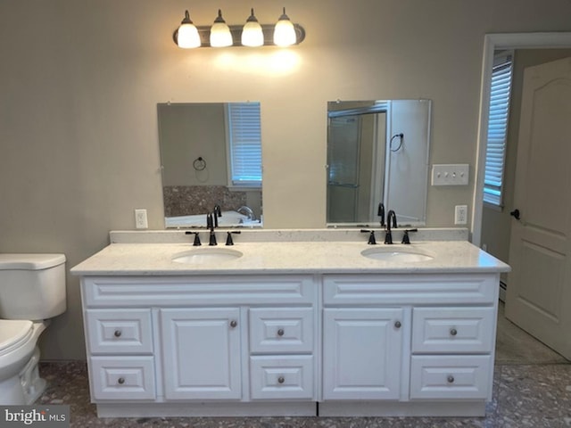 bathroom with toilet, walk in shower, and vanity