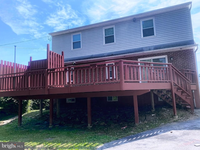 back of house with a deck