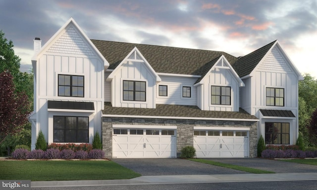 view of front of home with a yard and a garage