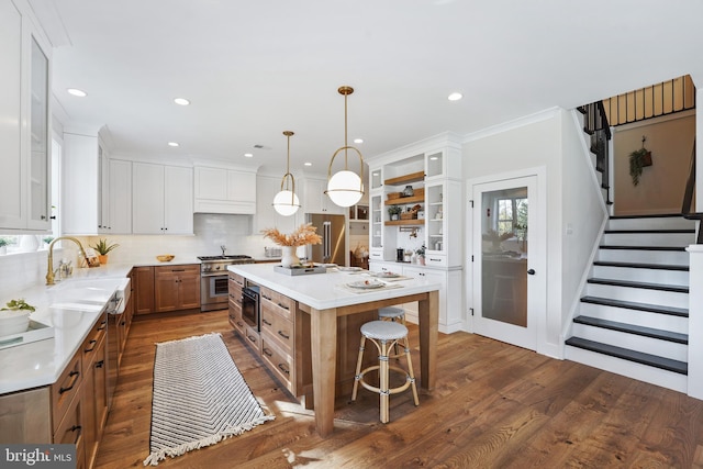 kitchen featuring white cabinets, a center island, and decorative light fixtures