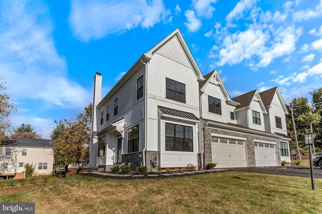 view of front of property featuring a garage and a front yard