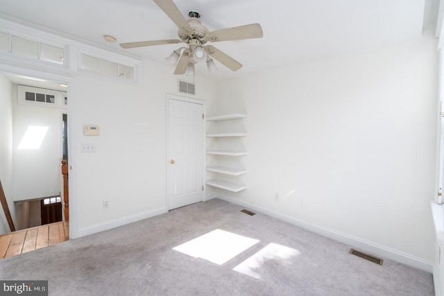 unfurnished bedroom with light colored carpet and ceiling fan