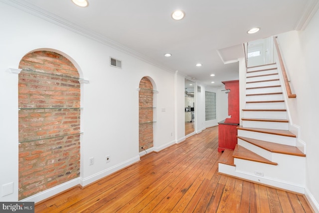 interior space with crown molding and hardwood / wood-style floors