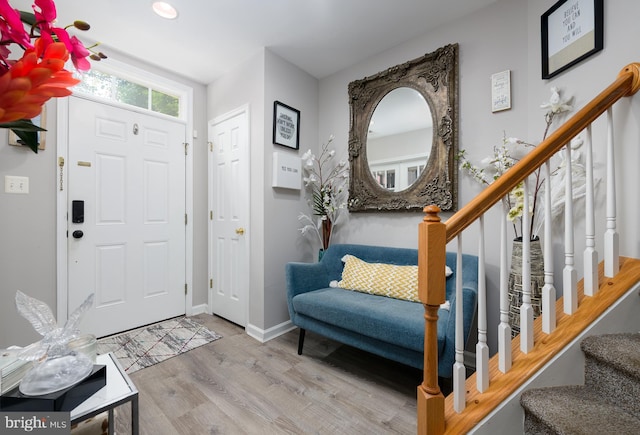 foyer entrance with light hardwood / wood-style floors