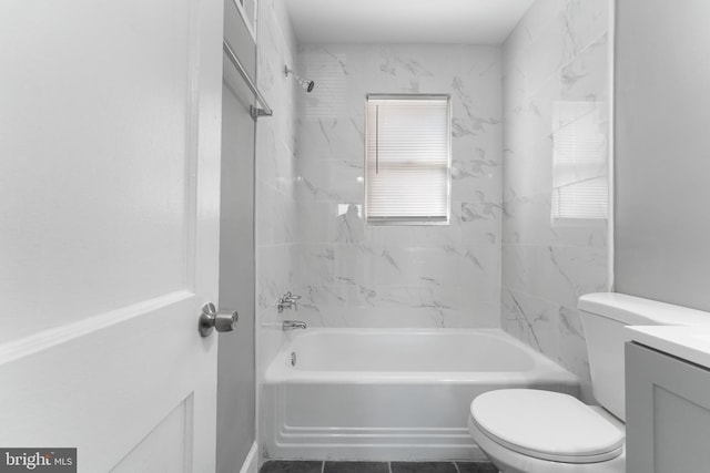 full bathroom featuring vanity, tiled shower / bath, toilet, and tile patterned flooring