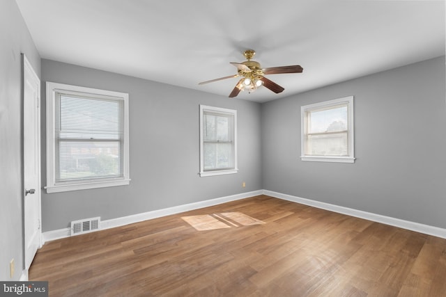 spare room with wood-type flooring and ceiling fan