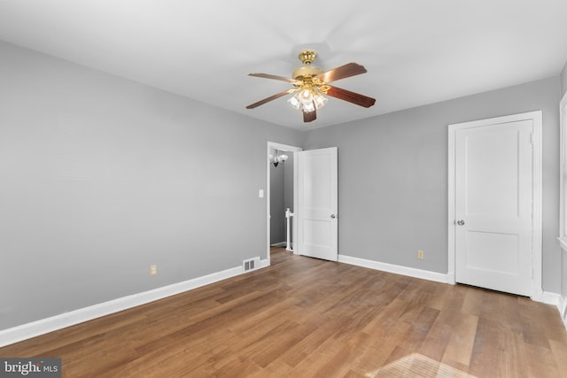 unfurnished bedroom featuring hardwood / wood-style floors and ceiling fan