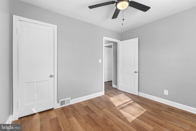 unfurnished bedroom with hardwood / wood-style floors and ceiling fan