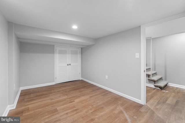 finished basement with light wood-type flooring and baseboards