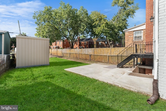 view of yard with a storage shed and a patio