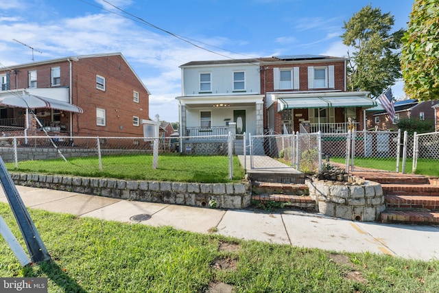 view of front of home with a front yard and a porch