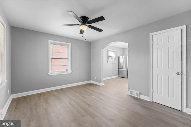 spare room featuring light hardwood / wood-style floors and ceiling fan