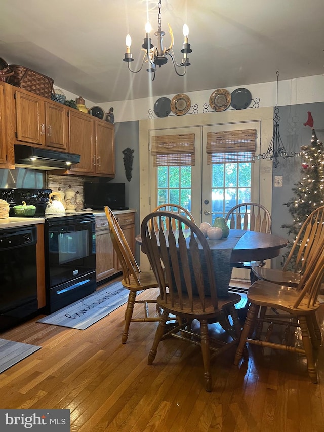 dining space featuring a notable chandelier and hardwood / wood-style flooring