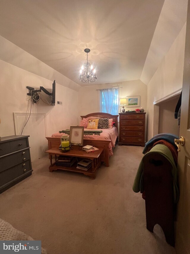 carpeted bedroom with lofted ceiling and a chandelier