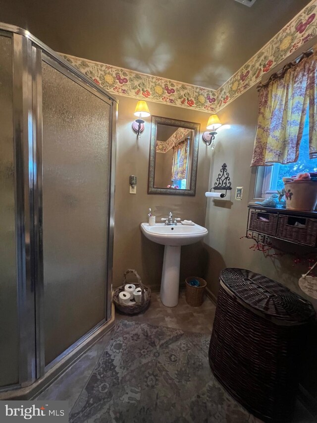 bathroom featuring sink and an enclosed shower