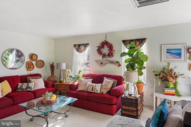 carpeted living room with ceiling fan