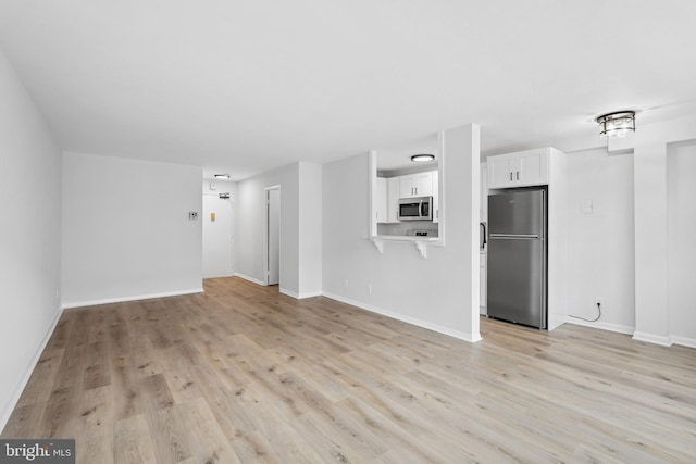 unfurnished living room with light wood-type flooring